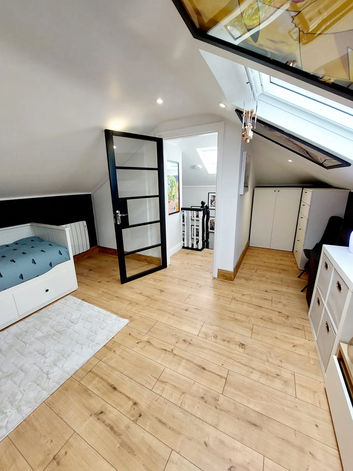 Attic conversion bedroom with apex ceiling, Velux skylight and eaves storage
