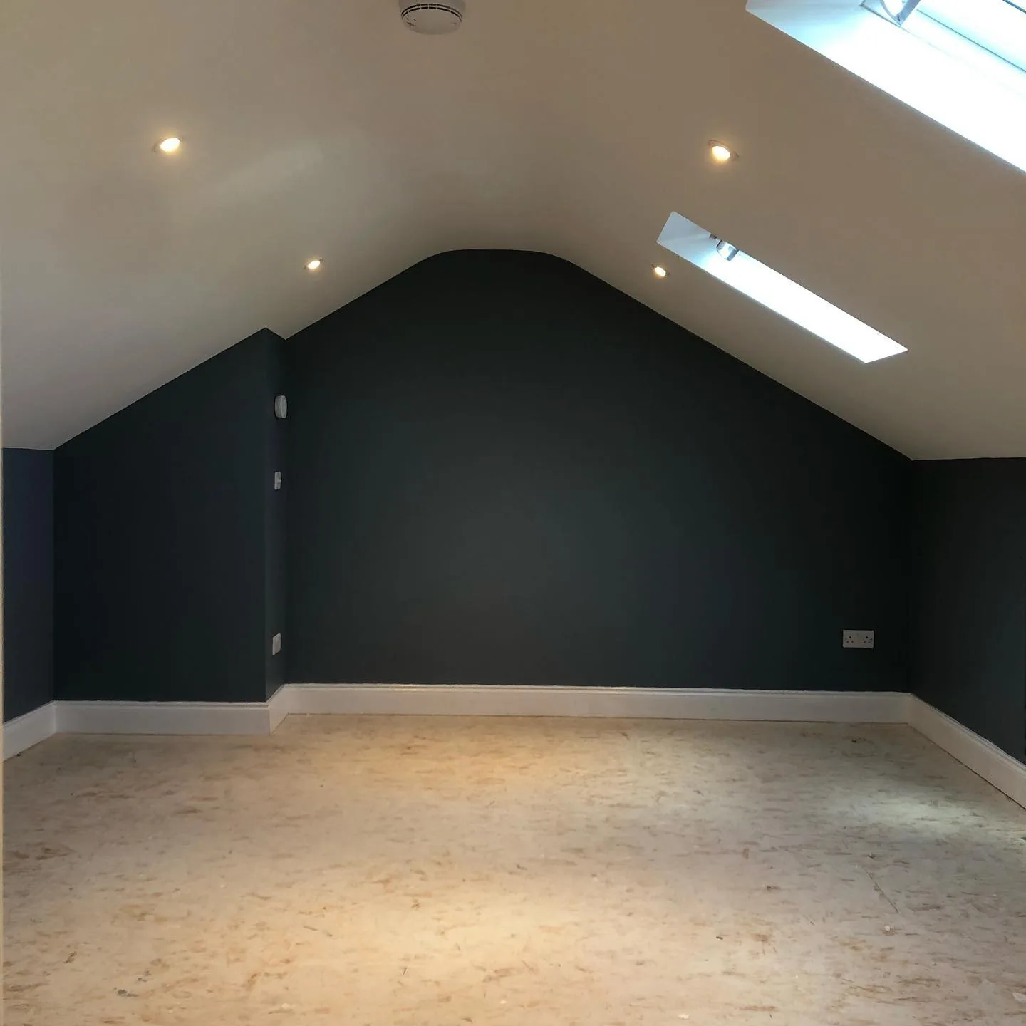 Whitechurch attic with navy-painted apex feature wall